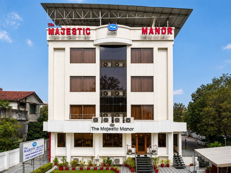 The Majestic Manor hotel exterior with green surroundings